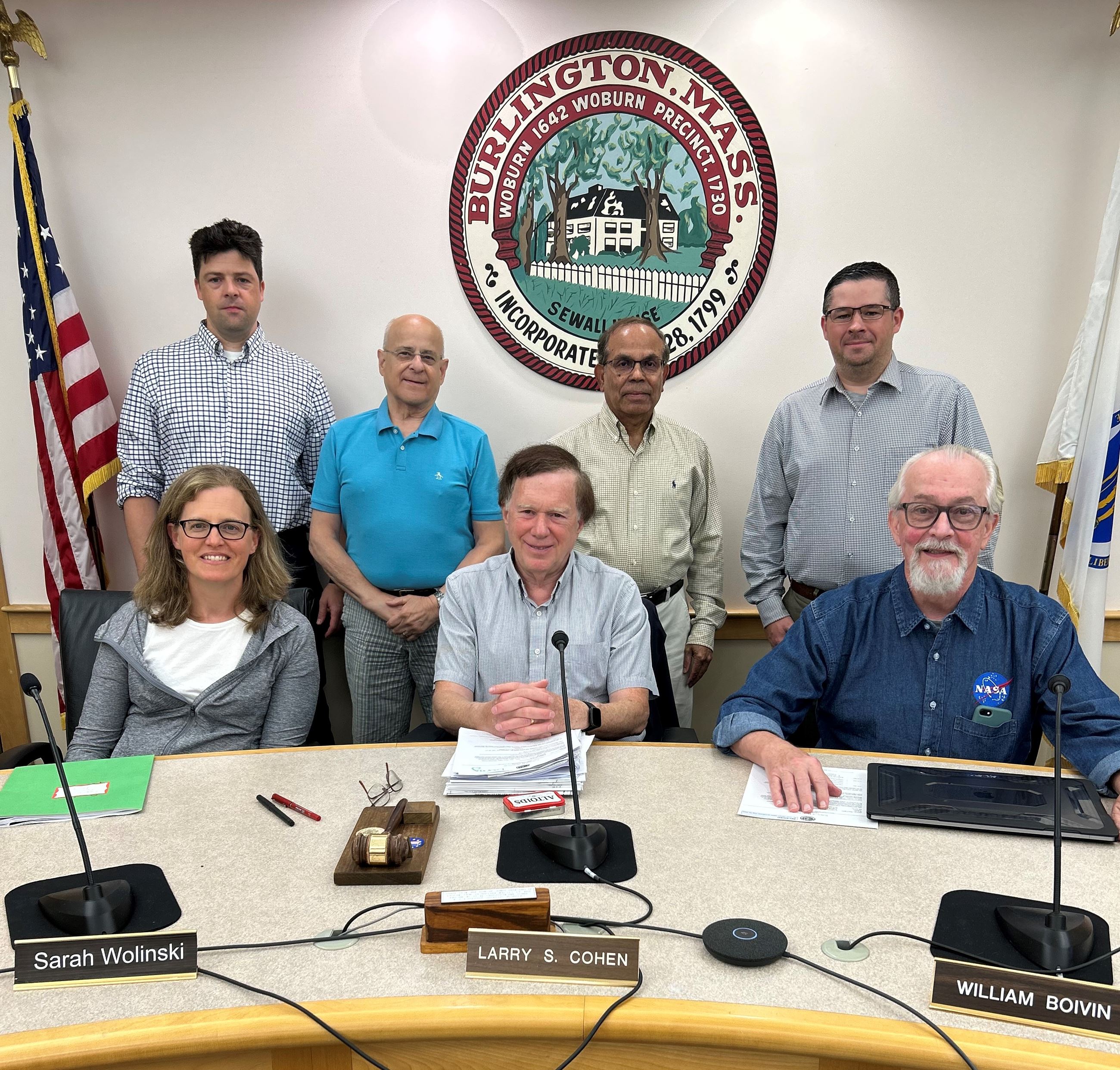 seven conservation commission members behind a table with name plates