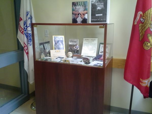 Glass Case Containing Documents and Information About the Vietnam Moving Wall